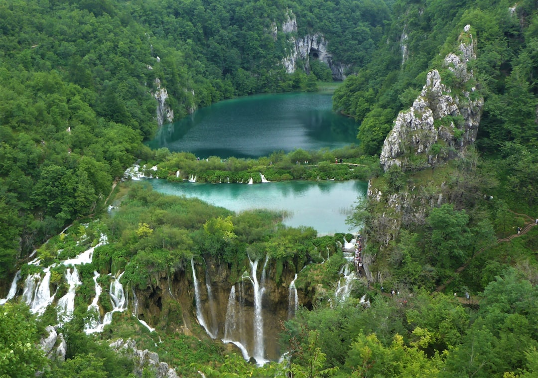 Crystal clear turquoise water with waterfall at Plitvice Lakes